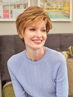 Paula wig by Envy, short layered style with warm highlights and side-swept fringe.